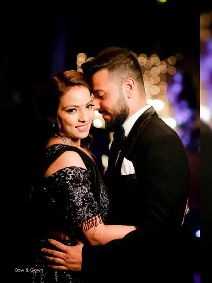 A close-up, intimate portrait of the couple at their reception. The dark, moody lighting adds a touch of drama and romance to their embrace.
