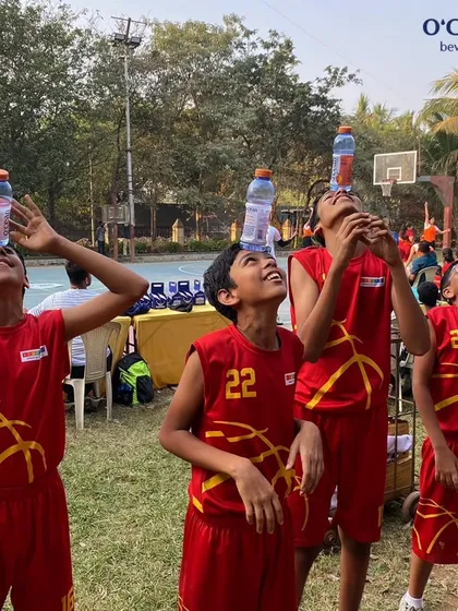 It's not always serious. Players having some fun balancing bottles during a break at the MVP Skills Challenge. It's about community and enjoying the day.