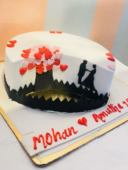 The full view of the heart-shaped silhouette cake, personalized with the couple's names and anniversary date.