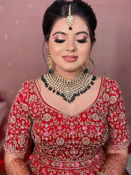 A close-up with eyes closed, showing the beautiful blend of the eyeshadow and the neatness of the bun.