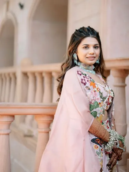 A repeat of a beautiful Haldi look with soft waves and a double braided crown, perfect for a romantic, bohemian bride.