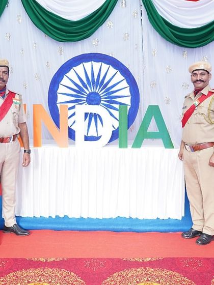 Police officials posing in front of a patriotic photo booth we designed for an Income Tax Department event. We create engaging and thematic installations for guests.