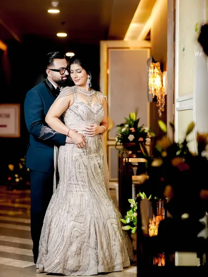 An elegant indoor portrait of the couple, using the ambient light of the venue to create a warm and sophisticated mood.