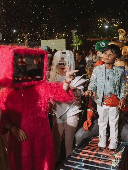 The birthday boy, Sanay, looking like a star amidst a crowd of futuristic and fantasy characters. My goal is to make the guest of honor the hero of their own story.