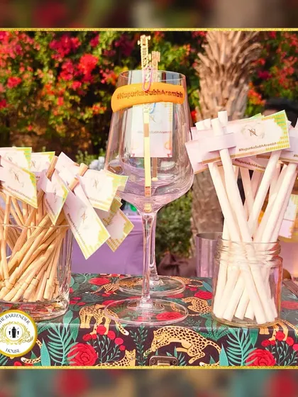 A closer look at our personalized drink tags and stirrers, set against a vibrant, tropical-themed bar cloth. Every detail is curated to match your event's theme.