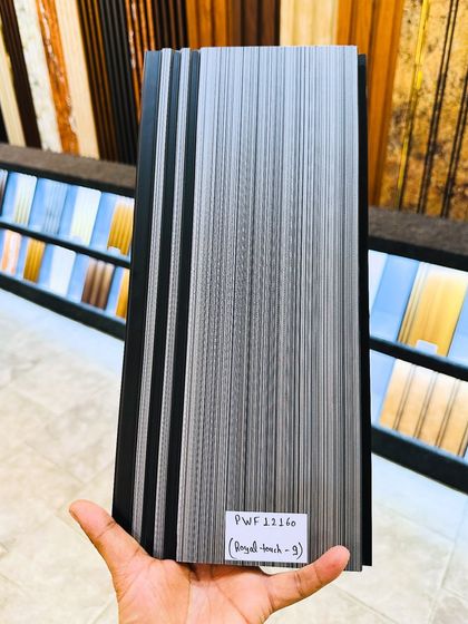 This fluted panel features a 'royal touch' with a grey-black linear wood grain texture, perfect for a sleek and contemporary interior design.