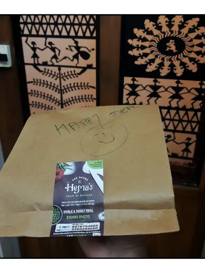 A happy meal, packed in a two layered bag with a smile, ready to be delivered.