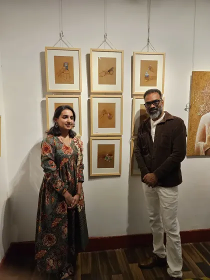 A photo with a visitor in front of my displayed work. I am always grateful for the people who take the time to come and see my art.
