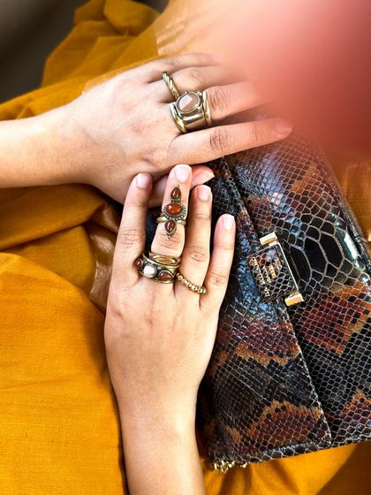 A detail shot of my accessory game for the yellow saree look. I stacked multiple brass and stone rings to complement the brown accents in my outfit.