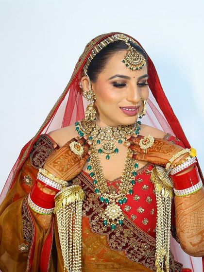 Our ravishing bride Bharti in a multi-toned lehenga, wearing a complete bridal set from us, including chooda and kaleeras.