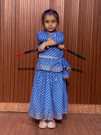 A confident pose from a young dancer in her blue bandhani outfit. Our classes help build stage presence and self-assurance in a fun, encouraging setting.