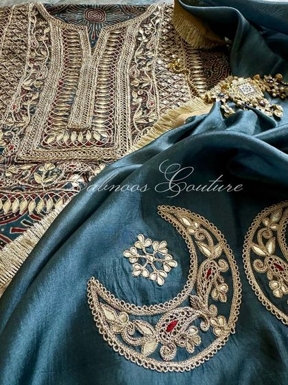 A close-up on the embroidered crescent moon motifs of the dupatta, which are meticulously crafted with Gota Patti work, echoing the details on the kurta.