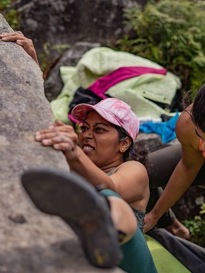 The grit and determination on this climber's face is inspiring. She is fully committed to the move.
