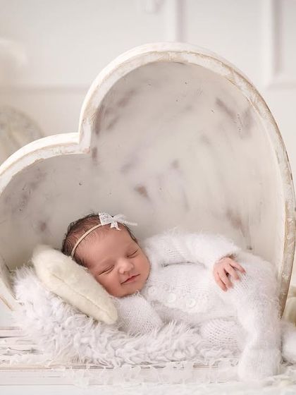 Another angle of our all-white heart theme, showing the baby smiling sweetly in their sleep.