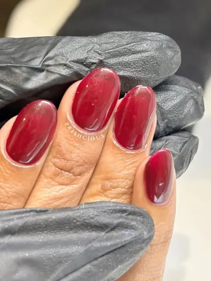 A close-up of the glossy, rich wine-colored polish. This shade is a timeless classic.