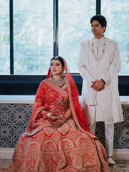 A classic portrait of the bride and groom. Her makeup is regal and timeless, complementing his elegant white sherwani perfectly.