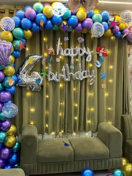 Another example of our mermaid theme, with a focus on the balloon arch and character foil balloons against a lit backdrop.