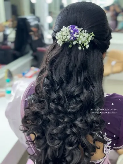 Bridal beauty is incomplete without the perfect hairstyle. Here is an example of a classic curly bridal hairdo, adorned with fresh flowers. In my certified hairstyling module, you will learn over 45 styles, from intricate buns to elegant curls like this one.