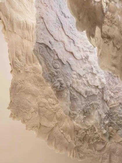 A detail shot of the hand-felted wool and stitched mul fabric from the 'Sleep Sense' installation. The textures are designed to be calming and cooling, reflecting the theme of the sleep revolution.