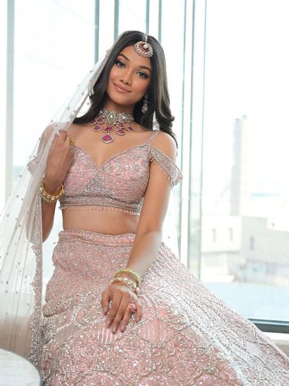 The complete picture of modern elegance. The soft pink lehenga and minimal makeup create a harmonious and breathtaking bridal look, perfect for the bride who loves understated style.