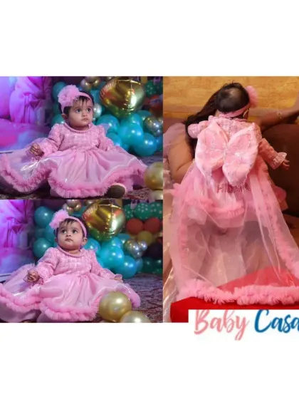 A princess in pink, ready for her royal celebration. This detailed gown features a long, detachable cape with a bow, making it a versatile and show-stopping outfit for a grand birthday party.
