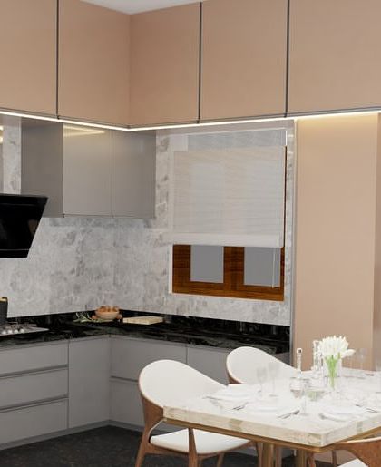 A 3D render of a modern kitchen and dining setup. The L-shaped kitchen features grey and beige cabinets, a black granite countertop, and an adjoining dining table for a compact and efficient layout.