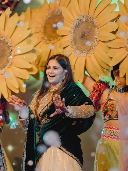 A guest enjoying the dance floor, surrounded by sunflower-themed performers. We integrate entertainment seamlessly with the decor.