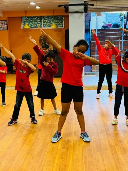 The whole team hitting the dab pose. This photo captures the fun, modern, and playful energy of my kids' dance classes.