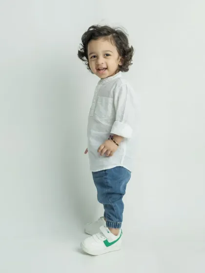 A candid side profile of the little boy, capturing his happy and curious nature.