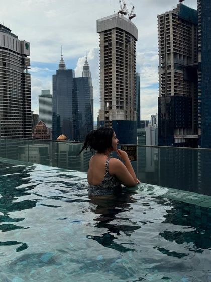 Another wallpaper-worthy shot from my photo dump. Me in an infinity pool overlooking the Kuala Lumpur skyline, including the Petronas Towers.