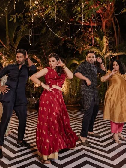The dance floor is alive! We love seeing guests let loose and have fun. This shot captures the pure joy and energy of a Sangeet performance under the twinkling lights.
