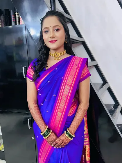 A full portrait of the client in a beautiful blue and pink saree. This look is elegant and perfect for a wedding guest.