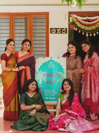 A "Maduve Mane" or "Wedding Home" welcome sign in Kannada, surrounded by the happy women of the family. I love adding these personal, local touches to make the celebration feel truly like home.