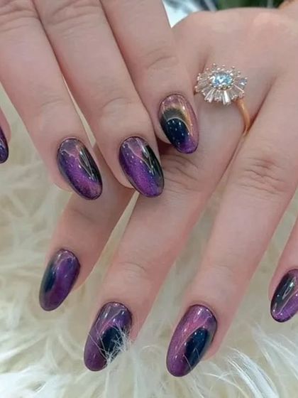 Another angle of the stunning galaxy cat-eye nails, a truly unique and artistic choice.