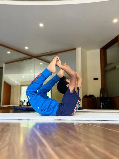Another one of our young students mastering the bow pose. We teach proper technique from a young age to build a strong and flexible foundation for any physical activity.