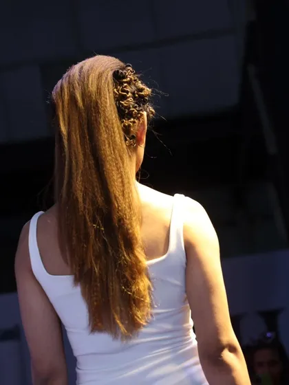 A unique, textured hairstyle from the back, featuring crimped sections and intricate styling.