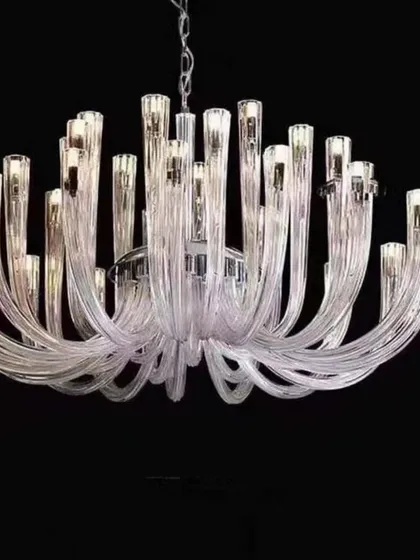 A clear glass version of the Castillo Spanish chandelier. Its transparent, fluid form creates a light and airy feel, making it a sophisticated addition to a modern or minimalist interior.