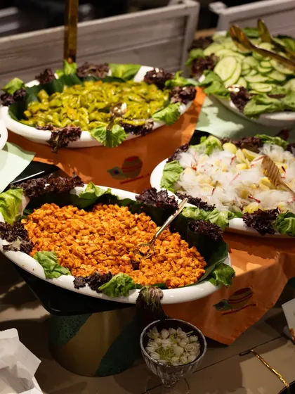 A colourful salad bar featuring a variety of fresh preparations. We offer a range of healthy and delicious options to complement our main courses.