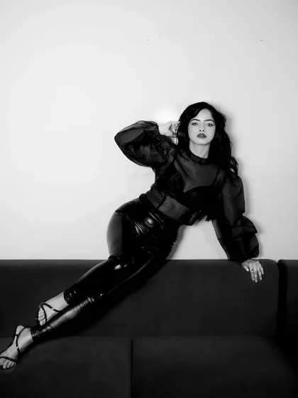A classic black and white portrait from an indoor session. The focus here is on mood and form, using simple lighting to create a timeless, high-contrast image that feels both vintage and modern.