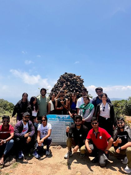 Mission accomplished. The group celebrates reaching the peak of Kumara Parvatha. The tough climb is all worth it for this moment and the breathtaking views.