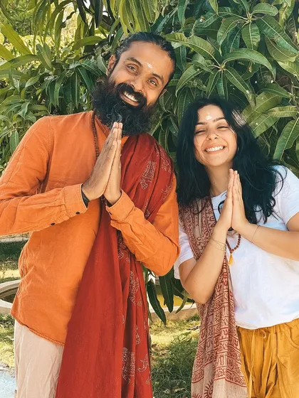 A student and I share a moment of greeting with "Namaste." This simple gesture embodies the respect and recognition of the divine in each other that we cultivate here.