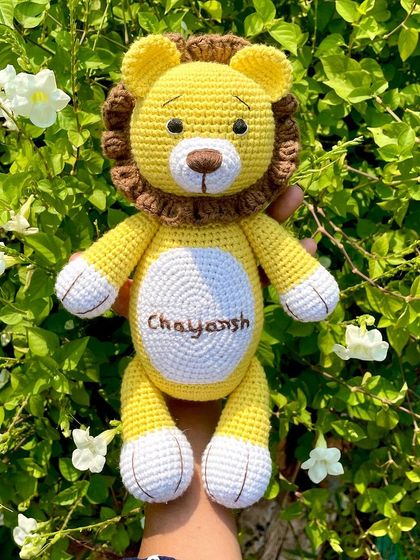 A personalized lion plushie with the name "Chayansh" embroidered on his belly. This sunny yellow lion is ready to be a brave and loyal friend.