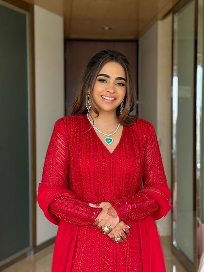 A smiling portrait of the bride-to-be. Her emerald heart necklace adds a beautiful pop of color.