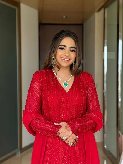 A smiling portrait of the bride-to-be. Her emerald heart necklace adds a beautiful pop of color.