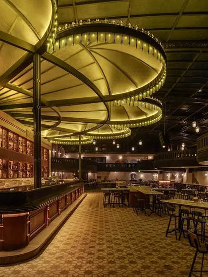 The main bar and seating area, showing the custom canopy lighting that defines the space. This is a prime example of using statement hospitality lighting to create a strong conceptual anchor.