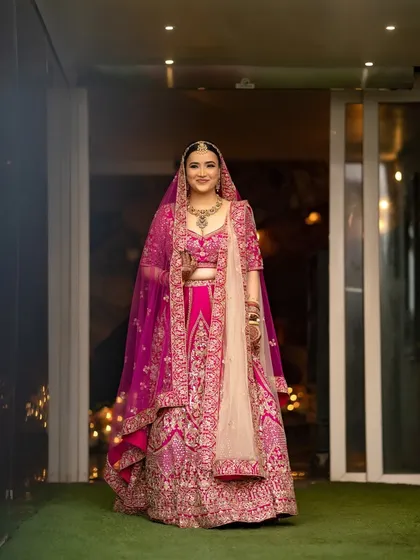 A full-length indoor portrait of the bride, showcasing her complete bridal look with grace and elegance.