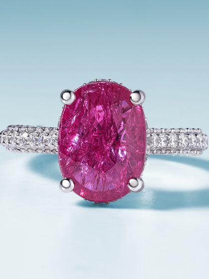 A fusion of passion and artistry. This ruby ring features a stunning oval-cut ruby on a band paved with brilliant diamonds. It is more than just jewellery; it is a statement of bold elegance.