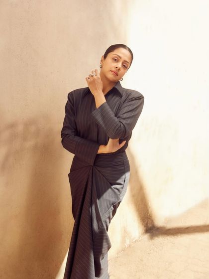 A full-length shot showing the innovative draping that mimics a saree, blending traditional and modern aesthetics.