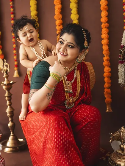A candid, playful moment with a yawning baby Krishna on his mother's back. These real, unscripted moments are what make a photoshoot truly memorable.