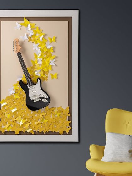 A vibrant shadow box for the electric guitar fan. A black and white guitar is surrounded by a cascade of yellow and white 3D butterflies, creating a beautiful and unexpected fusion of music and nature.